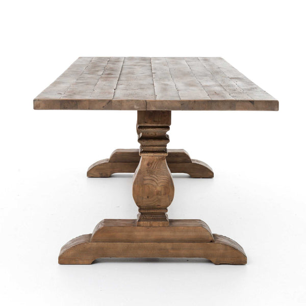 Rustic Durham Dining Table with reclaimed oak wood and turned trestle legs.