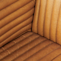 detailed view of the inside corner of a modern brown channeled leather sofa