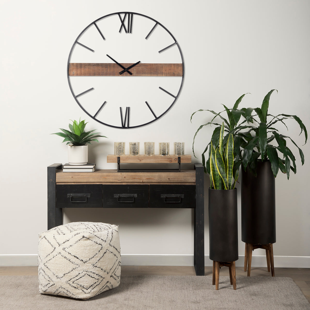 black metal oversize wall clock hanging on wall above industrial style desk