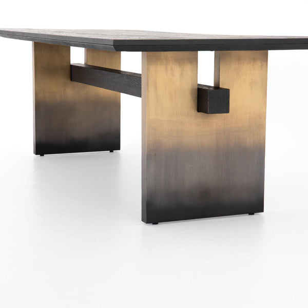 Brennan Dining Table with brass-finished legs and black oak tabletop featuring ombre pattern.