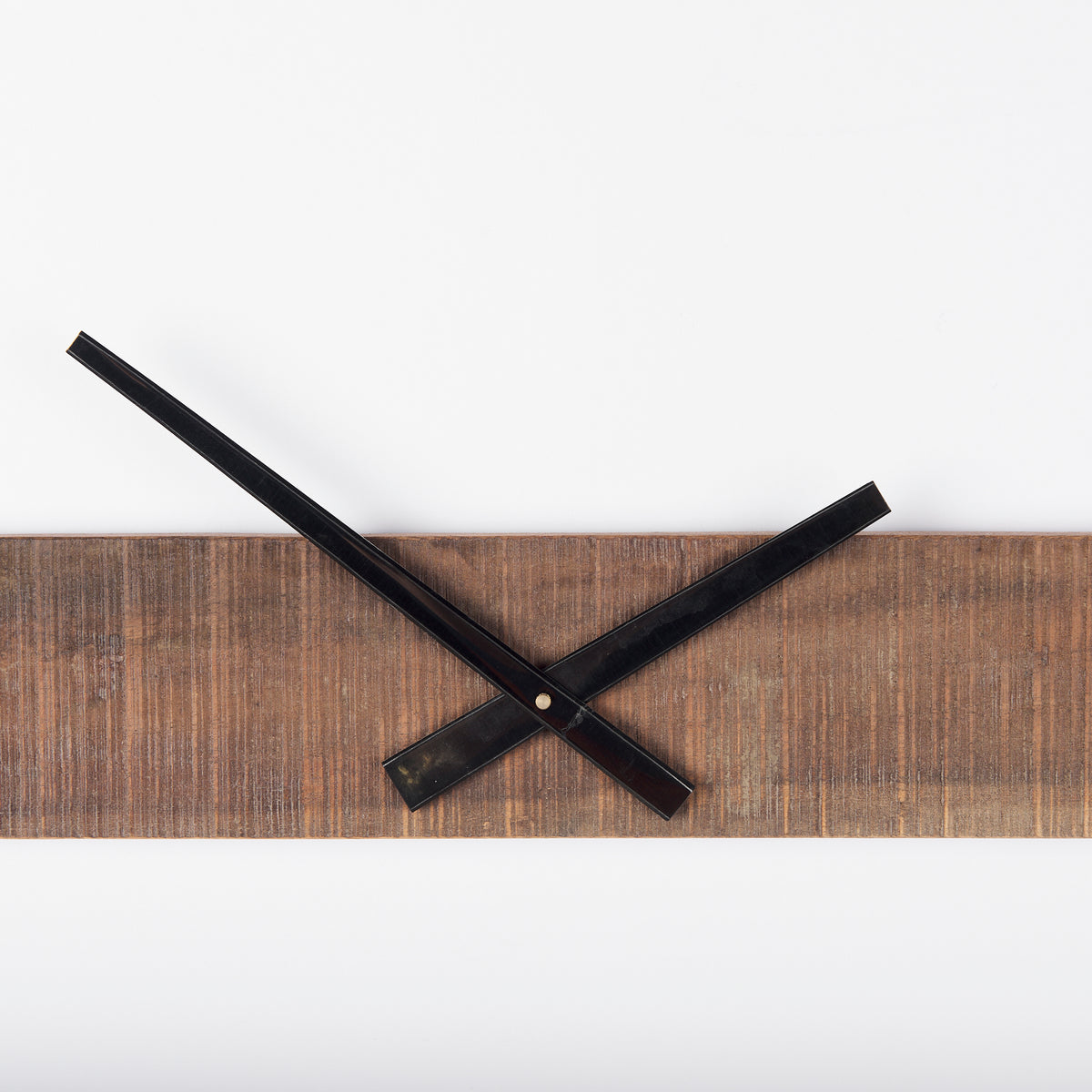 detail view of lack metal clock hands and wood accent - home decor